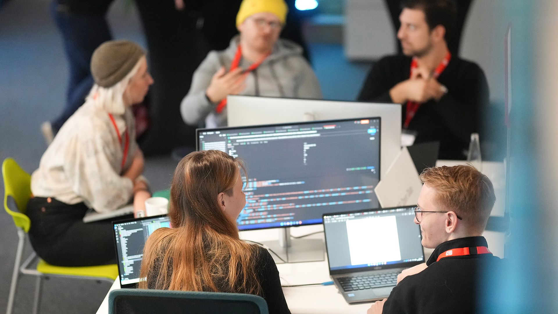 2 women and 3 men sitting at a table 