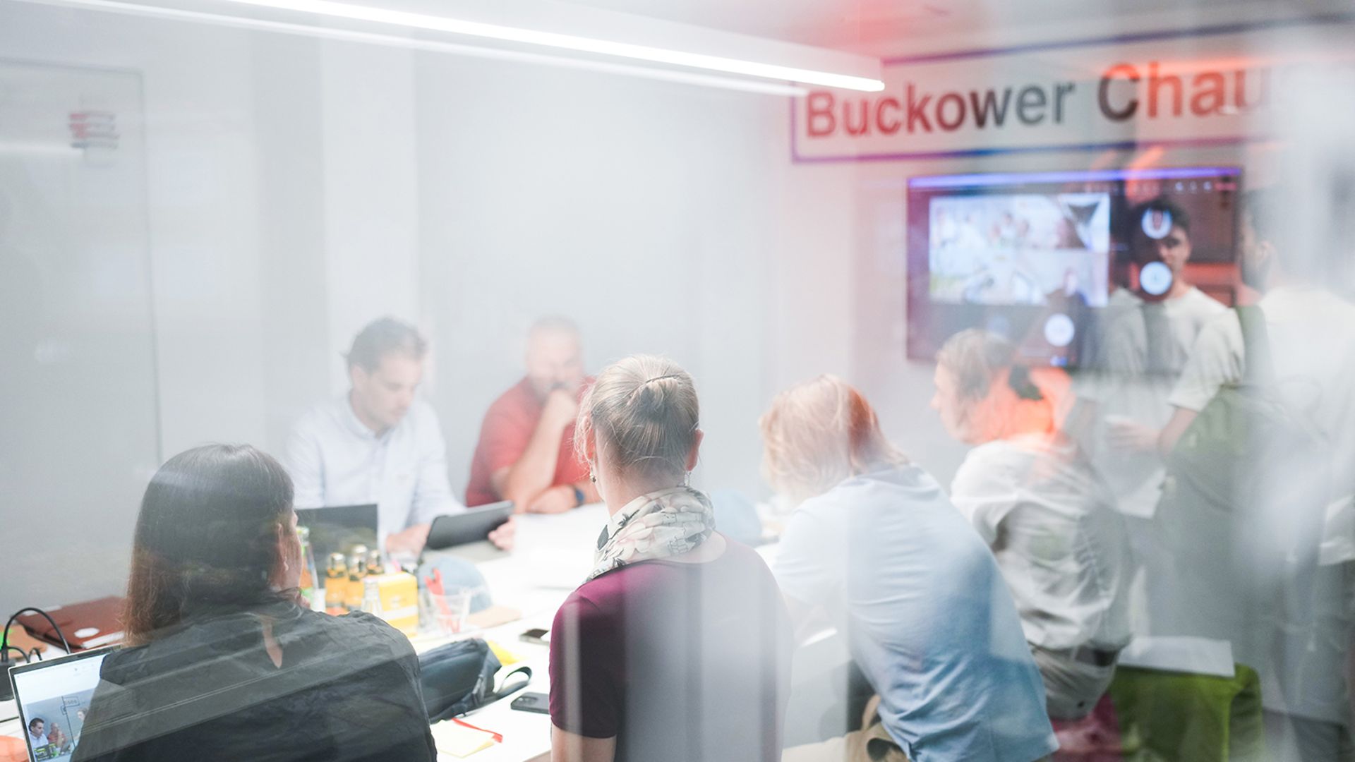 Several people are sitting in a meeting.