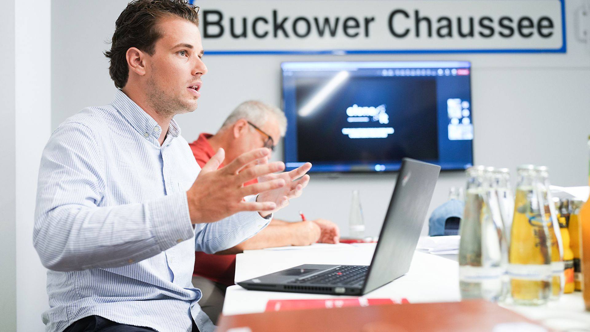 A man is giving a presentation in the Buchower Chaussee meeting room.