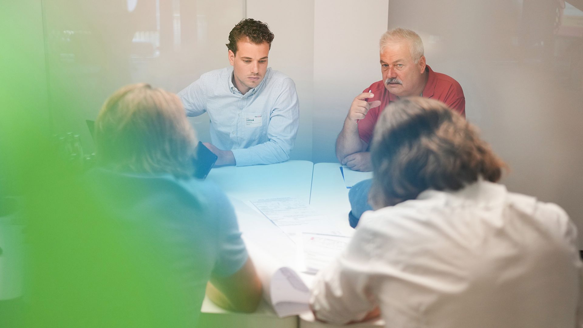 Several people are sitting in a meeting.